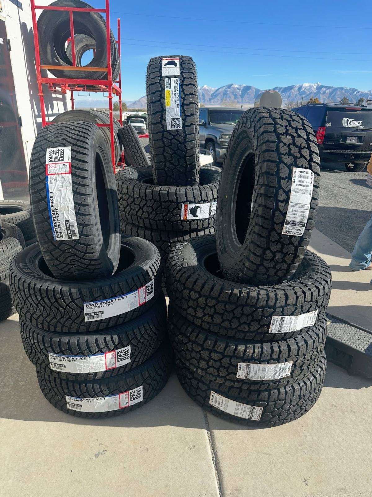 Stacks of new winter and all-terrain tires outside the Choice Tires shop in Grantsville